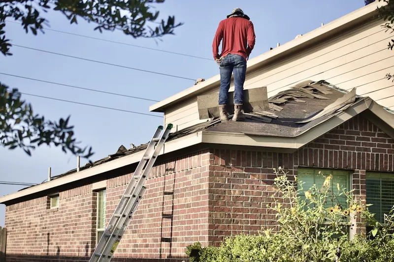 Professional roofer working on a residential roof in Downtown Dover